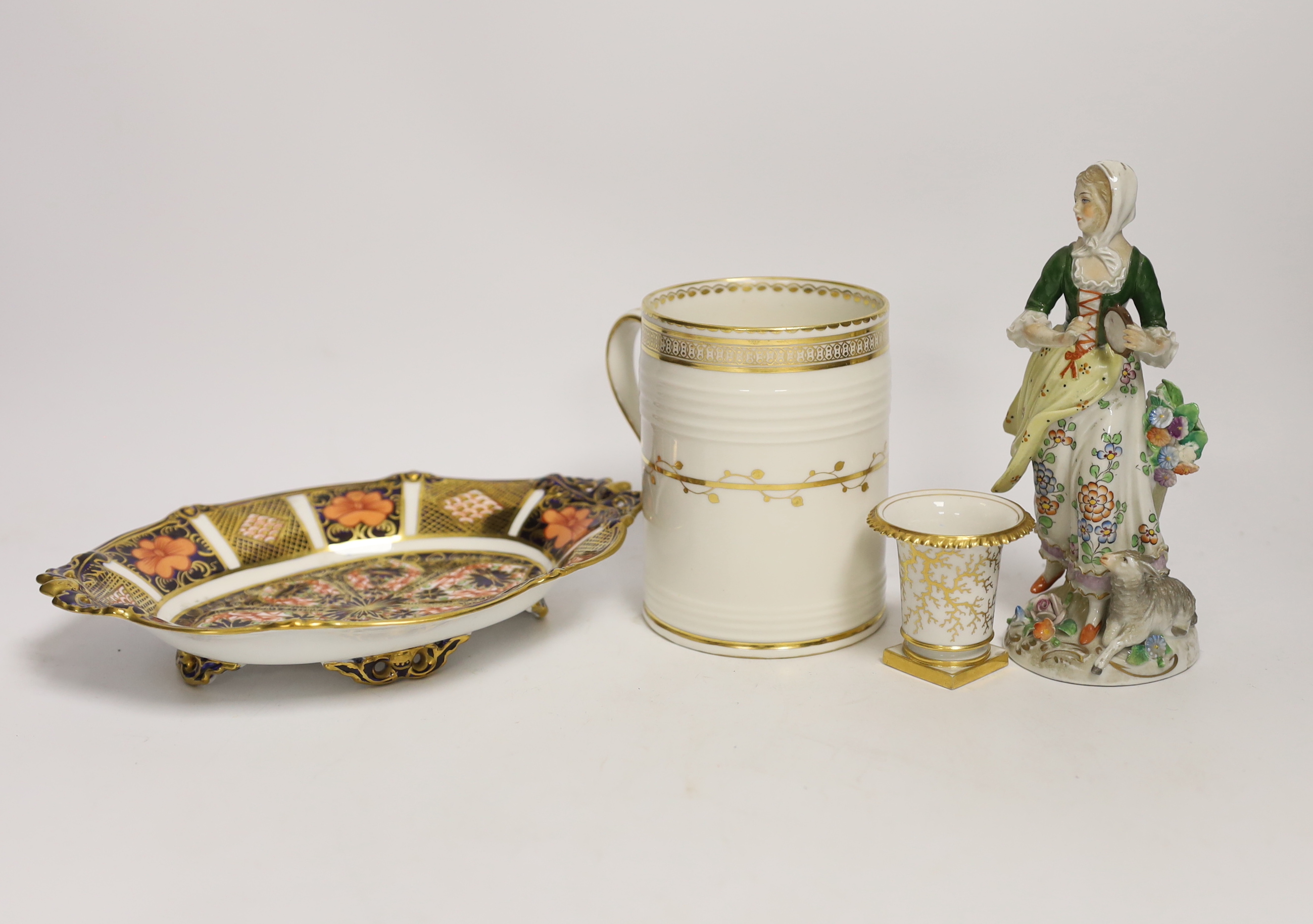Four porcelain items - a small Flight Barr & Barr Worcester she’ll painted vase, a Derby mug, a Royal Crown Derby dish and a Sitzendorf figure, 16cm